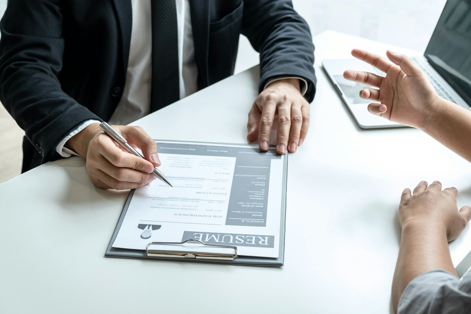Businessman interviewer consider a resume conversation during about profile of candidate